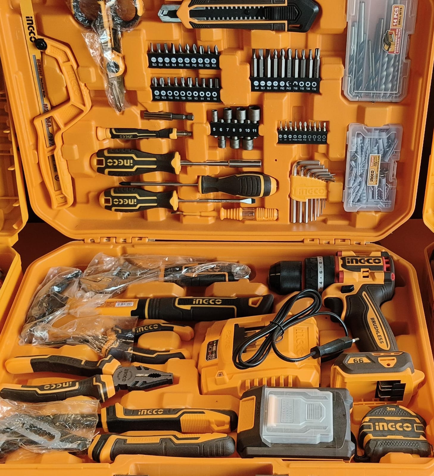 Row of INGCO-style cordless power drills and grinders on a workbench